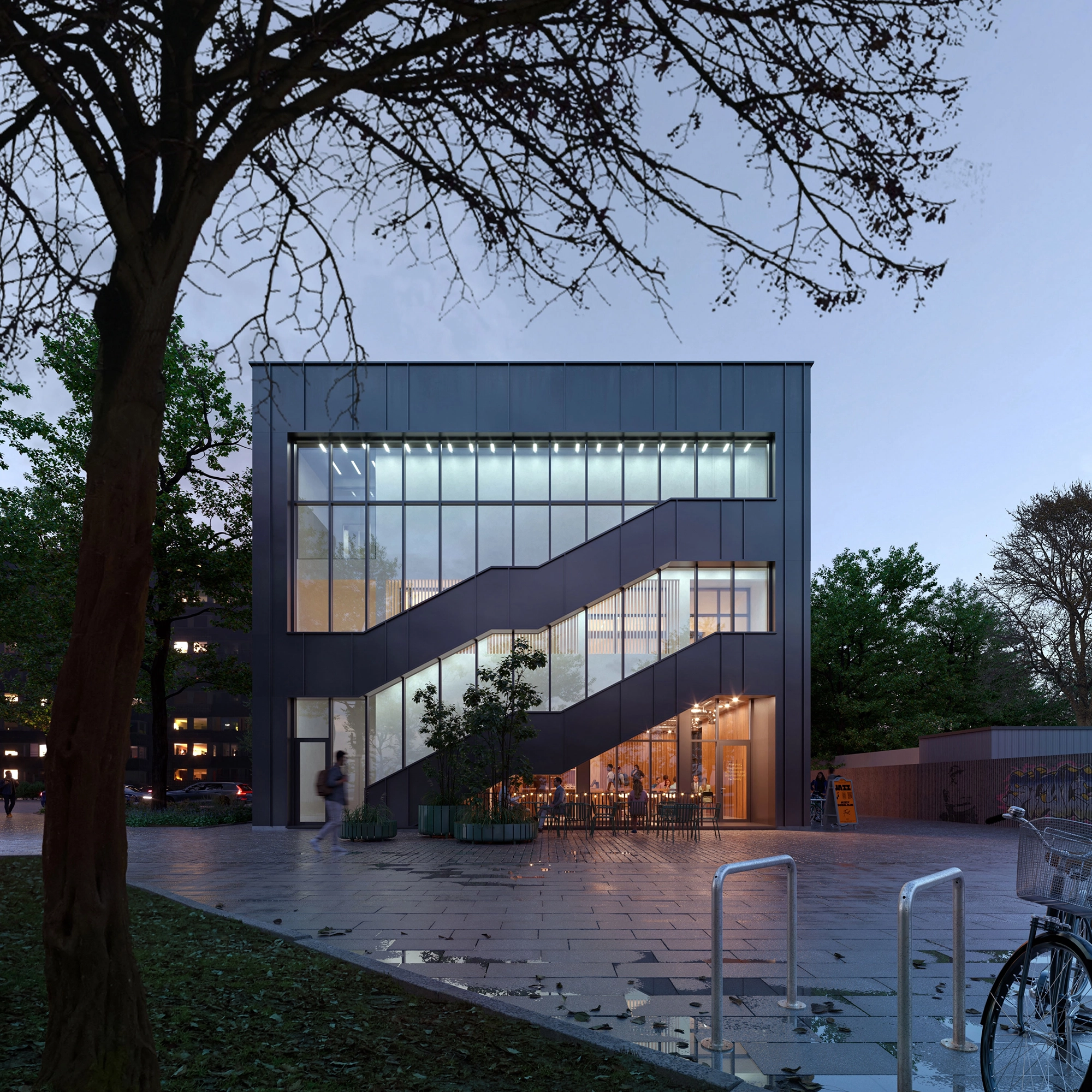 The Cube building in Borisov at dusk, its lit external stair crossing a dark metal facade above a corner cafe.