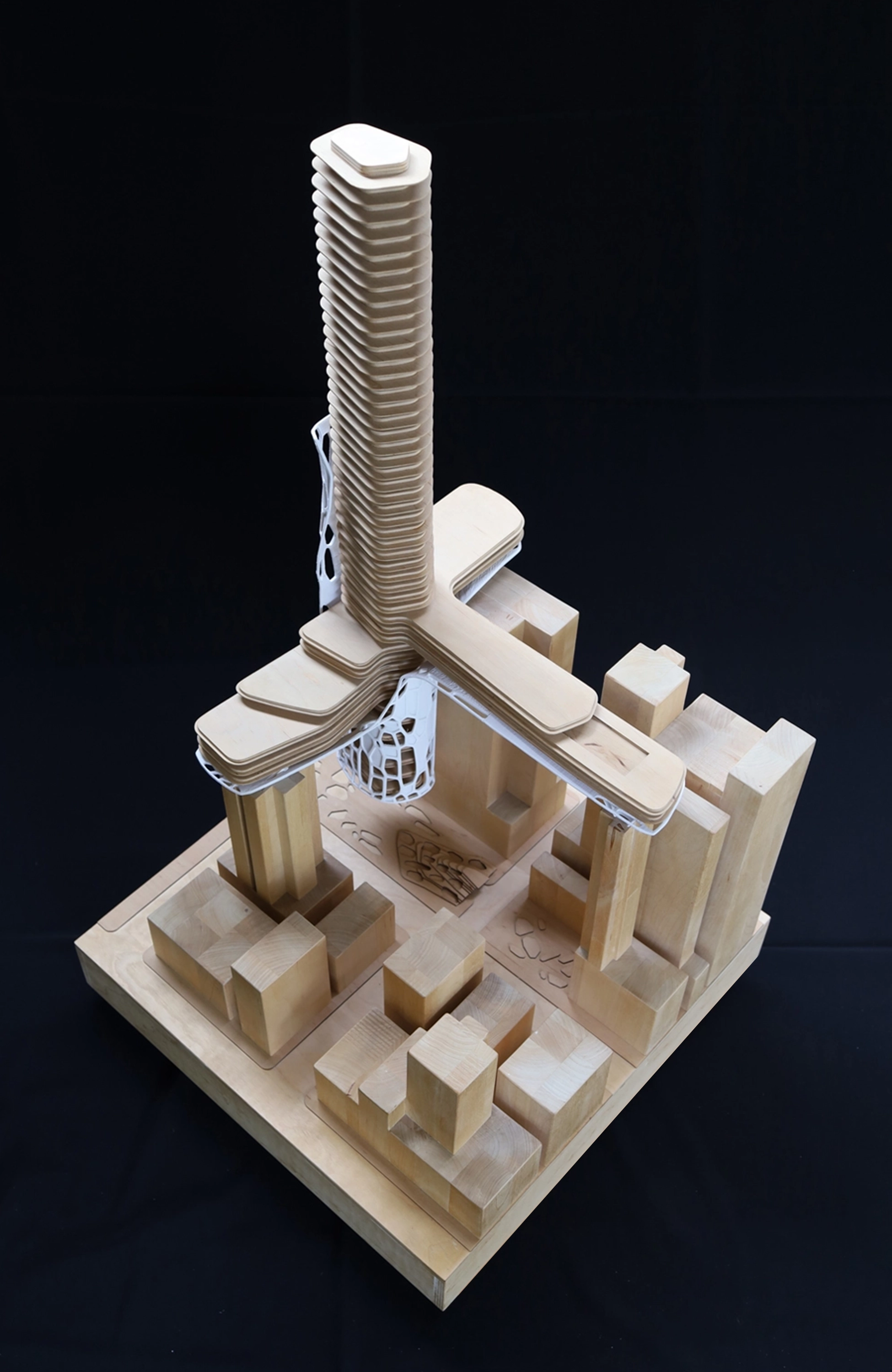 Physical architectural model of a tower and base buildings.